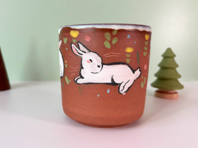 cute red stoneware cup with white bunnies