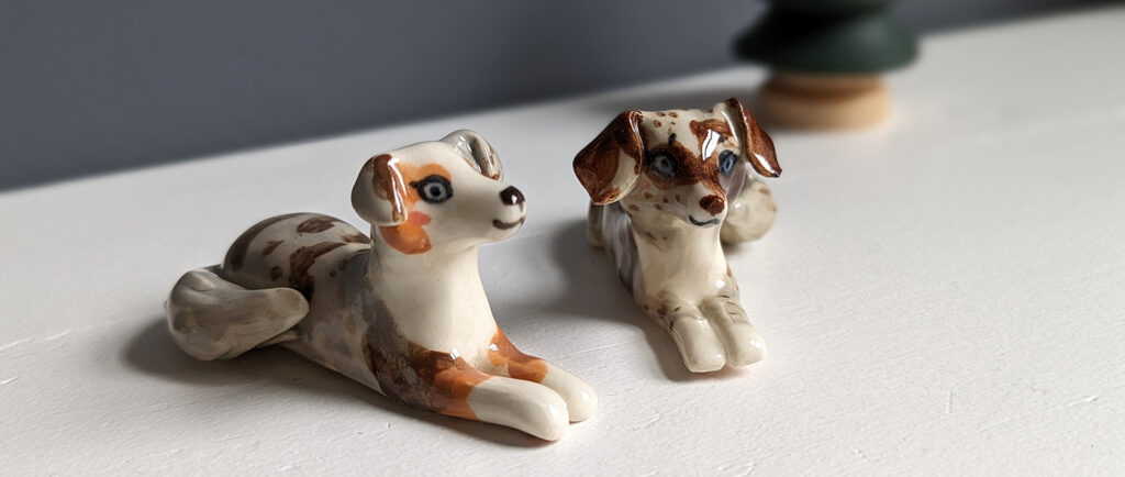 dog portrait figurines of two miniature australian shepherds