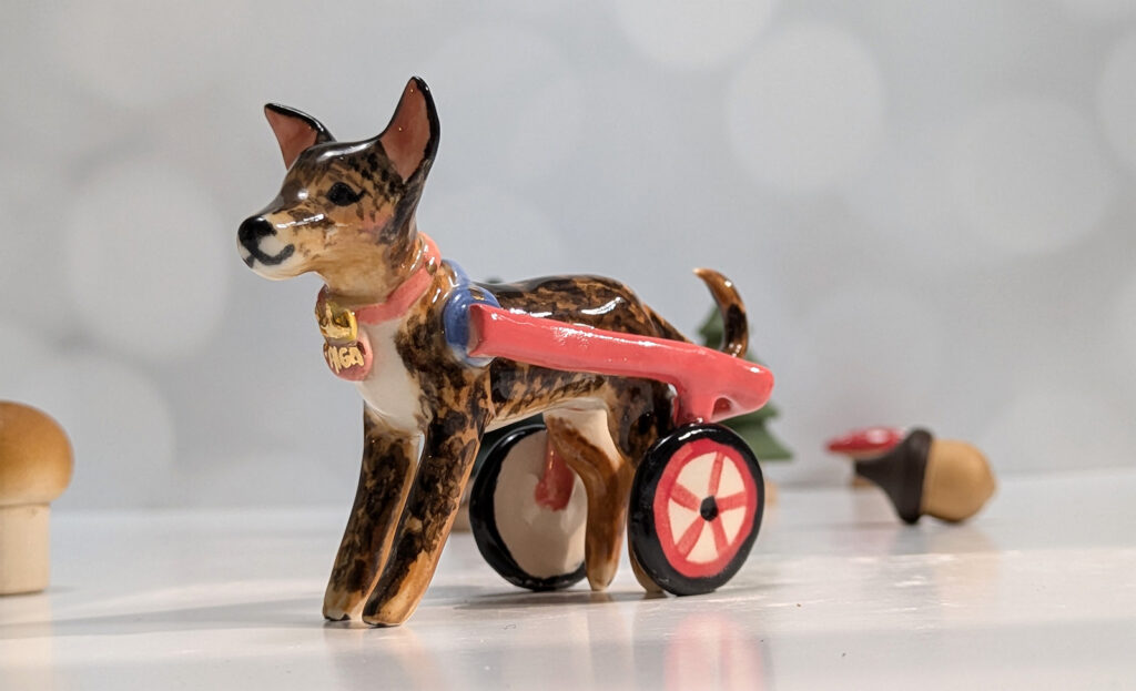 dog portrait figurine in a wheel chair