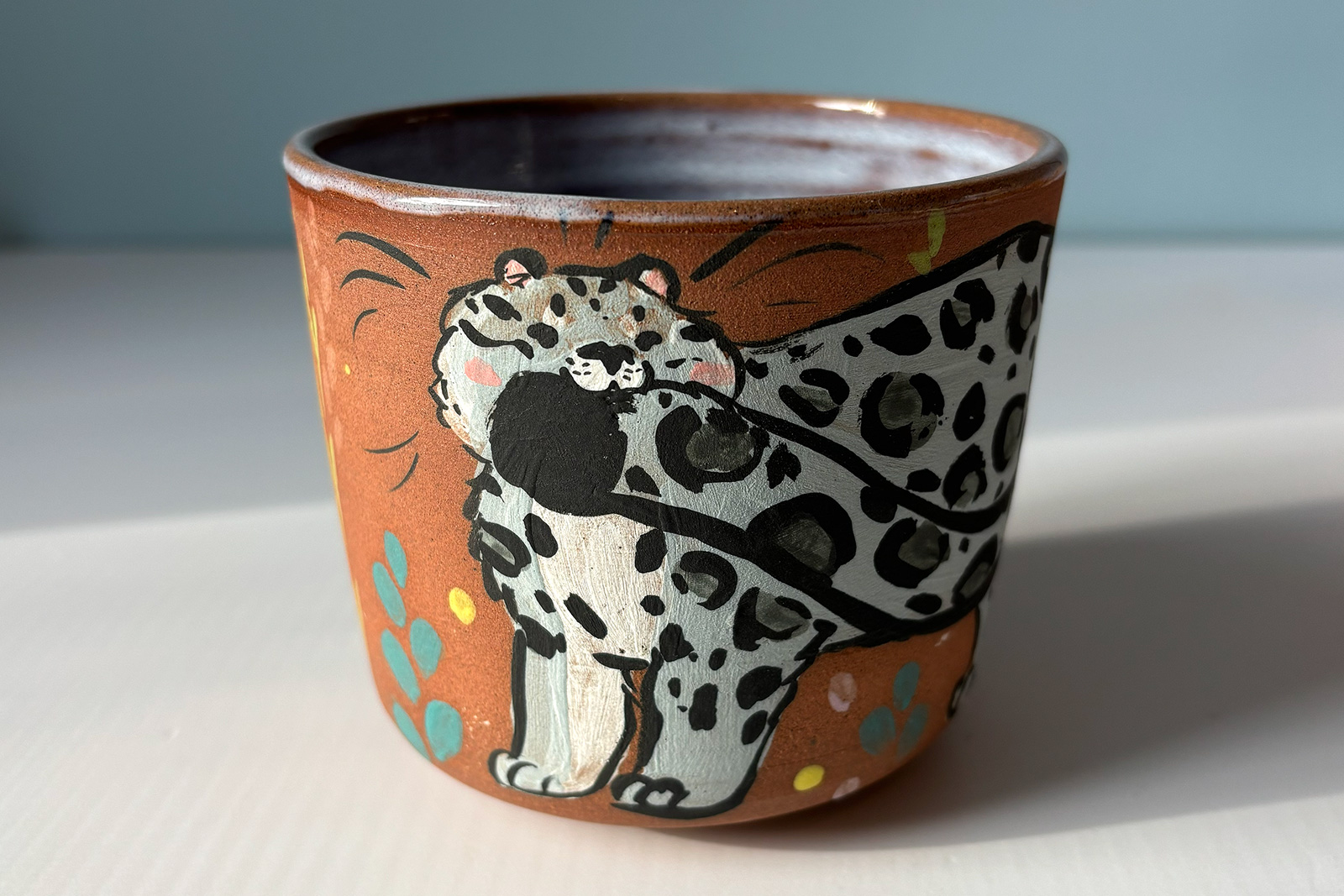 cute red cup with a snow leopard illustration handmade in Canada